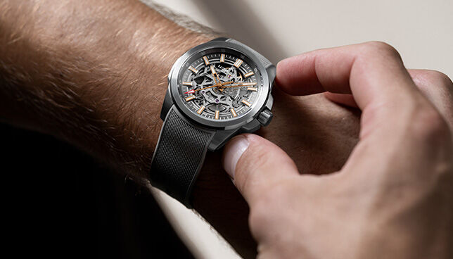 Detailed shot of NORQAIN skeleton dial watch with black rubber strap &ndash; modern Swiss engineering
